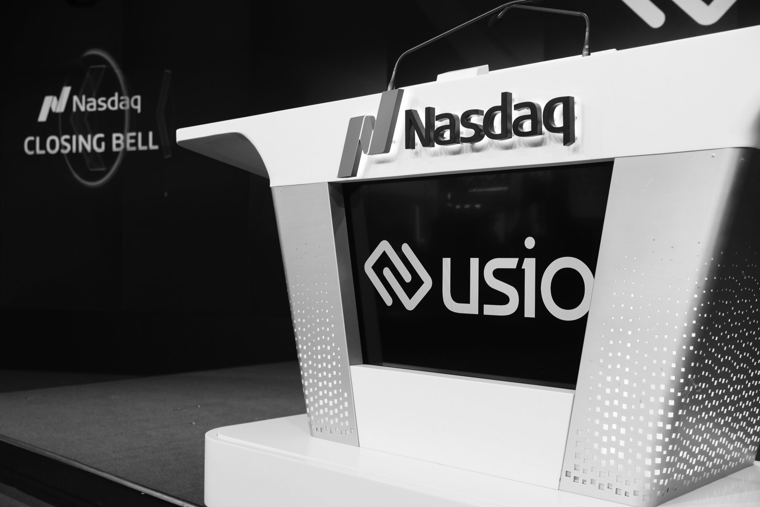 Usio branding on the Nasdaq closing-bell podium