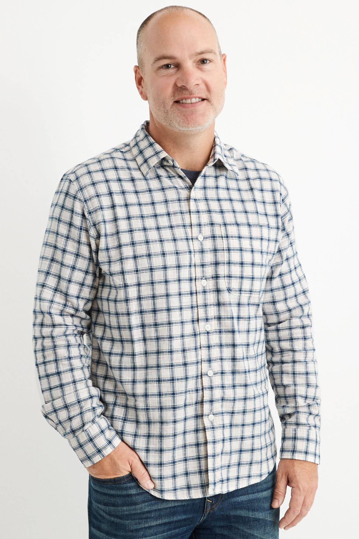 Michael Mathias in a checked shirt and jeans in an AEO press photograph