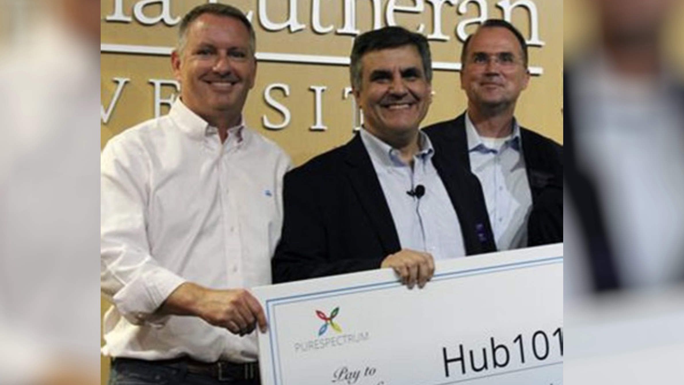 Michael McCrary, left, with university colleagues holding a presentation check for Hub101.