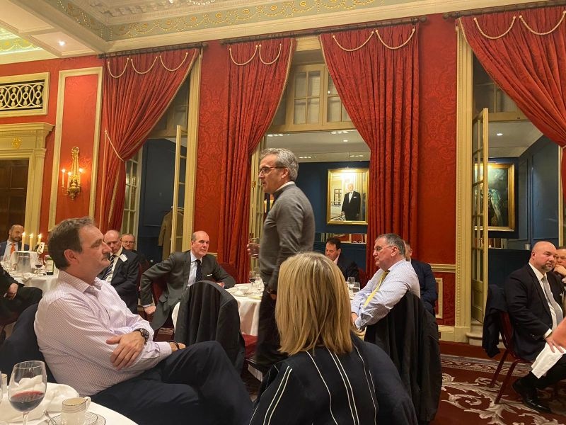 Michael Mueller standing to speak among guests at a Cornhill Club dinner