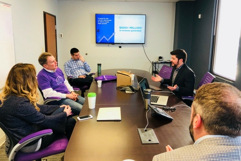 Michael Osborne speaking across a conference table during a visit to SmarterHQ
