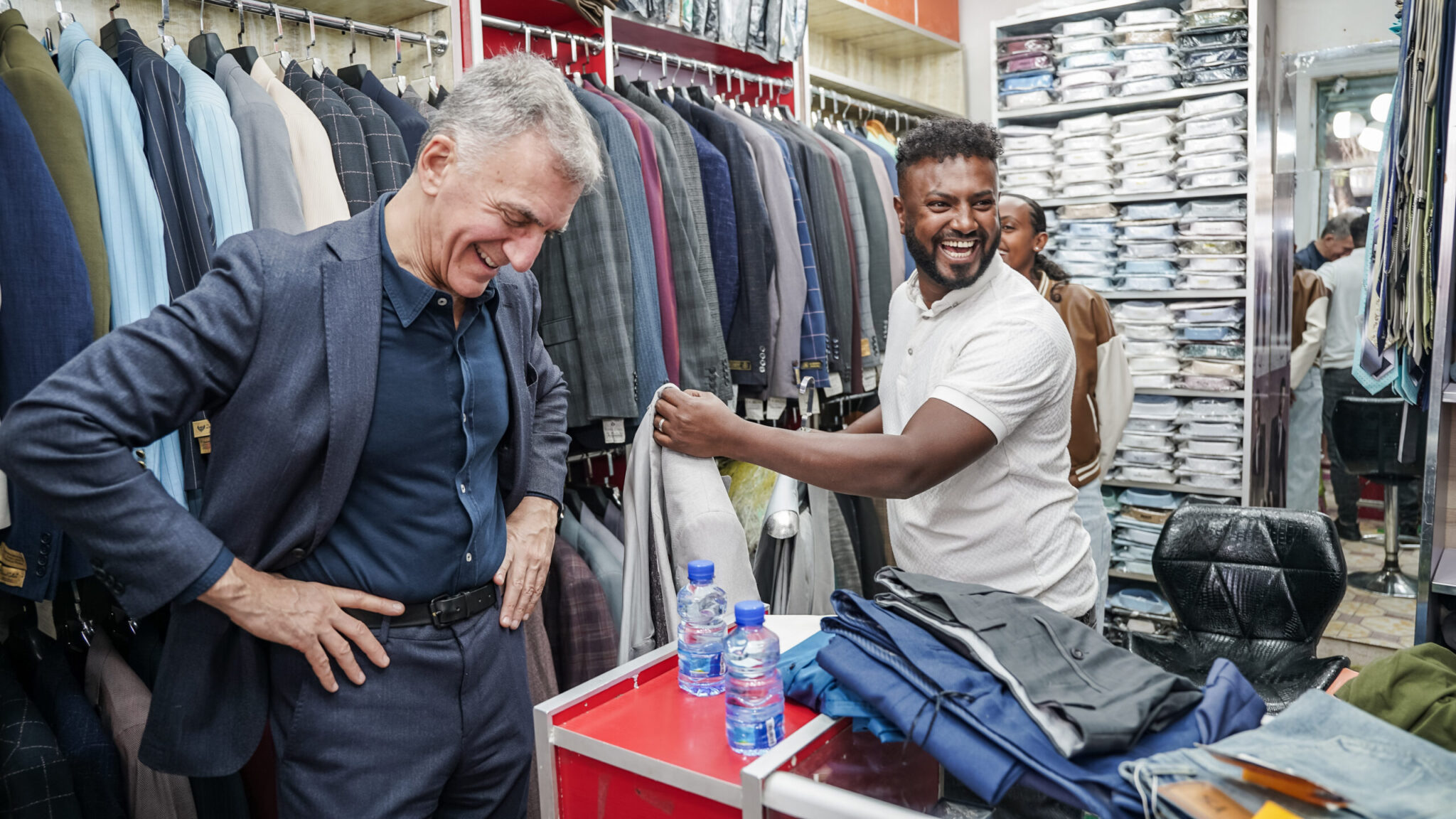 Michael Schlein smiling with Mohammed Side inside the Amazing Style clothing store in Addis Ababa