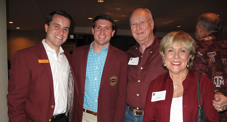 Michael Schramm, second from left, wearing a maroon blazer in a Texas A&M Foundation archival group photograph