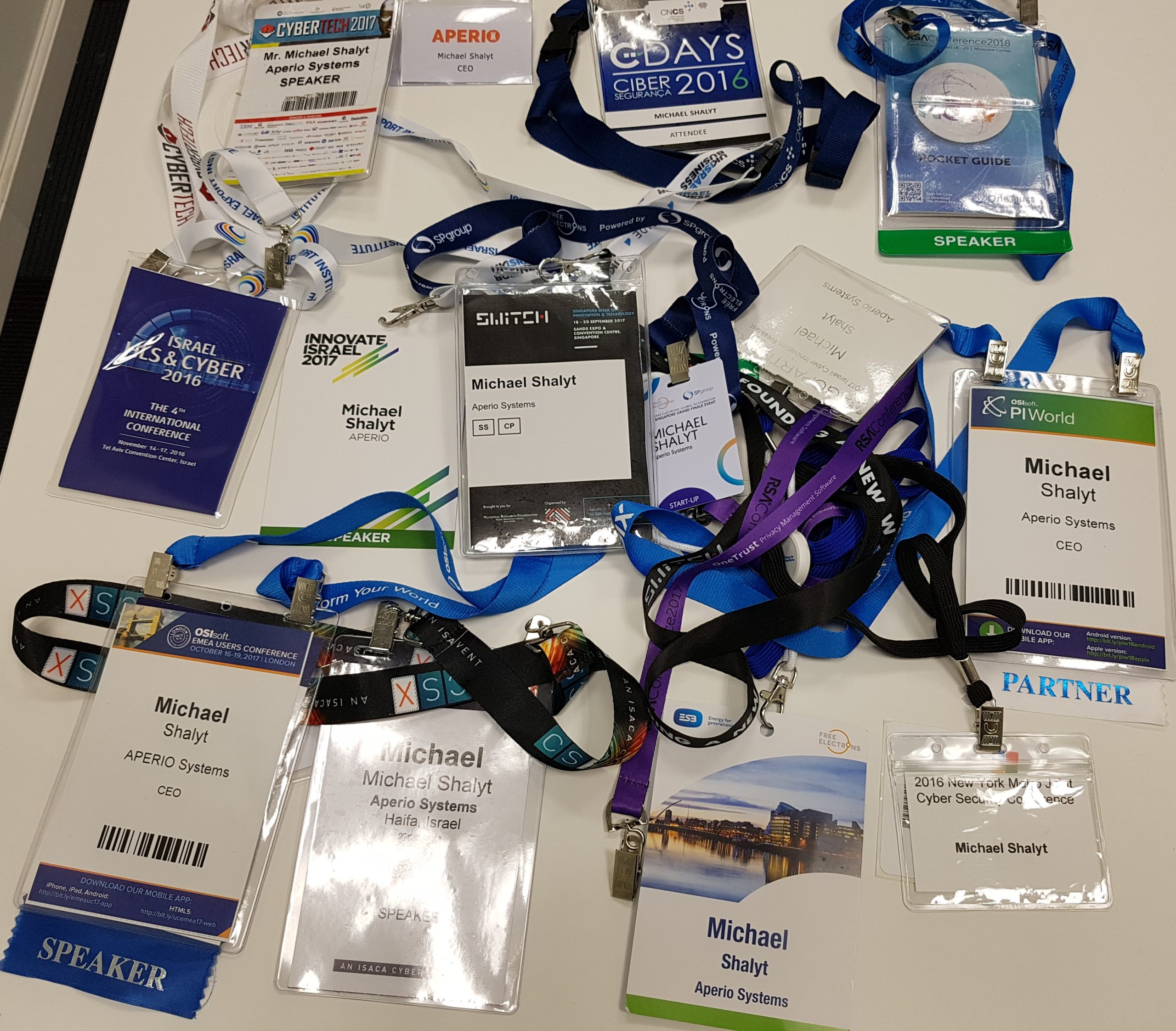 A collection of Michael Shalyt’s APERIO conference badges and lanyards