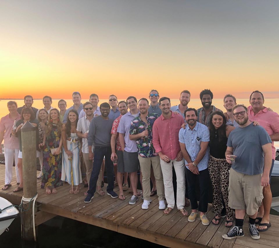 The Glew team gathered on a waterfront dock at sunset during its 2019 Islamorada retreat