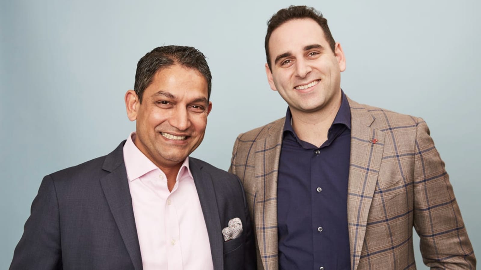 Yieldstreet co-founders Milind Mehere and Michael Weisz posing together