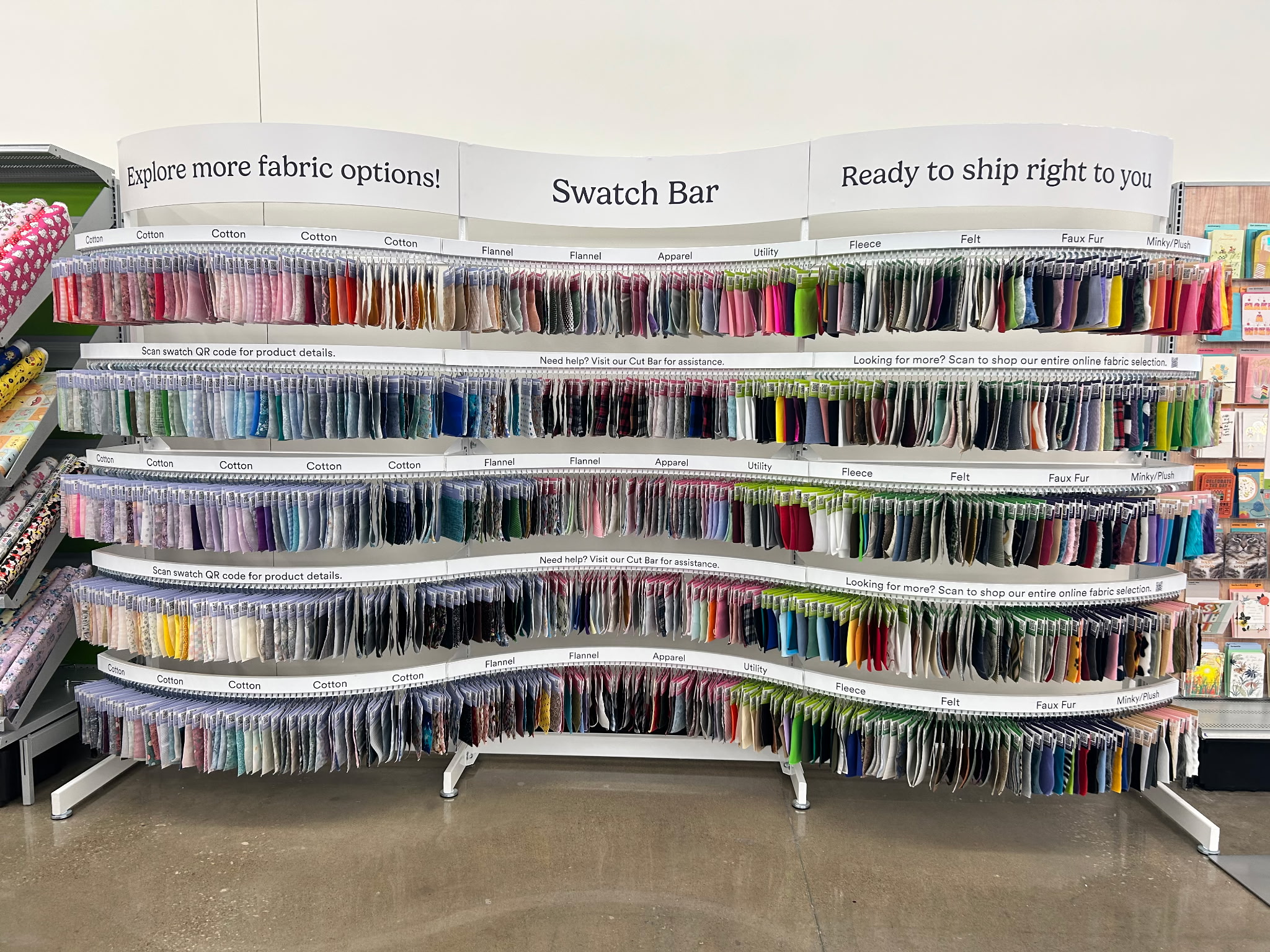 Rows of fabric samples at the Michaels Swatch Bar, labeled by material and linked to online ordering