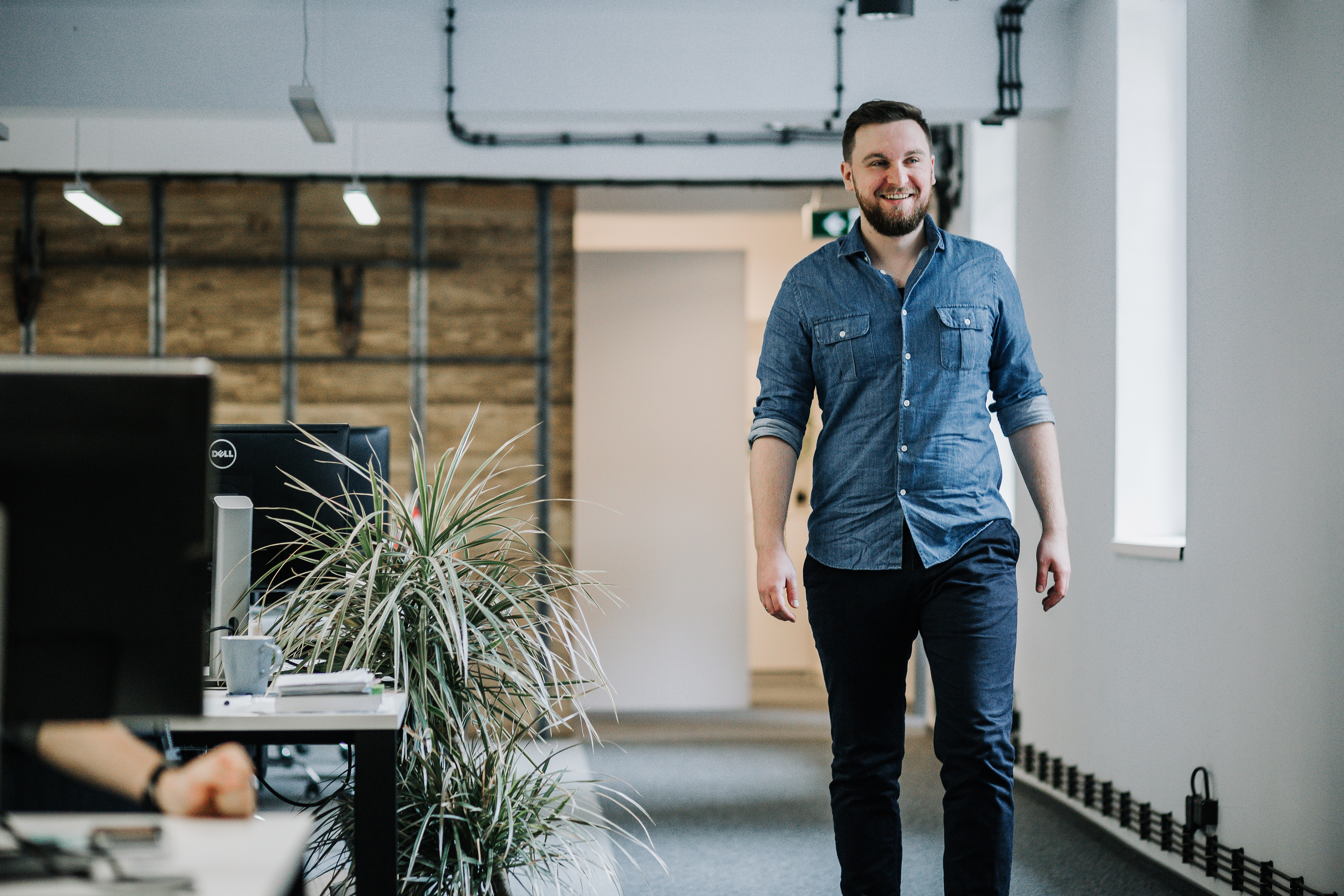 Michał Borkowski smiling in an office, beside desks and a window