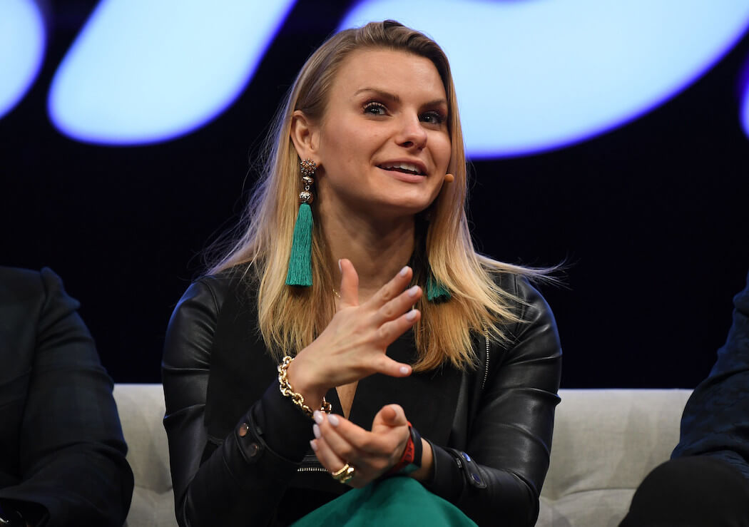 Michele Romanow speaking on a conference stage