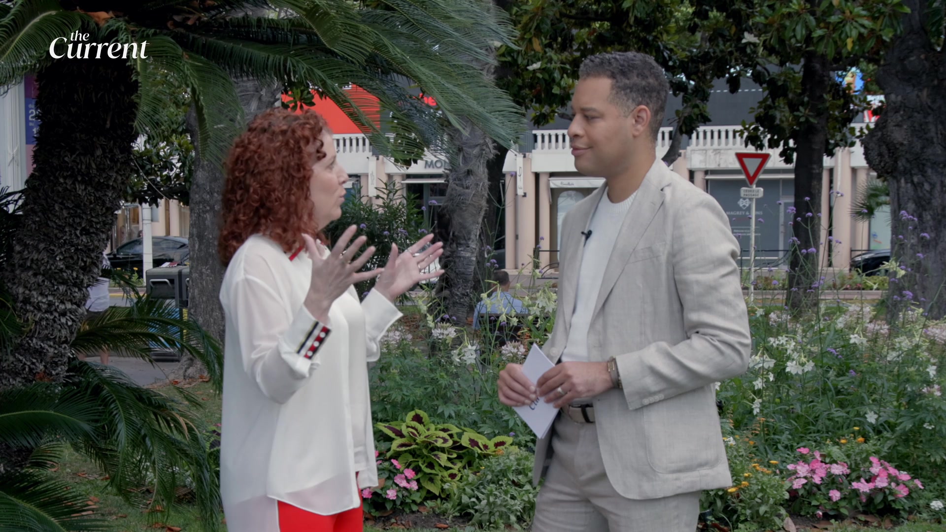Michon Martin gestures while speaking with interviewer Lee Singletary outdoors.