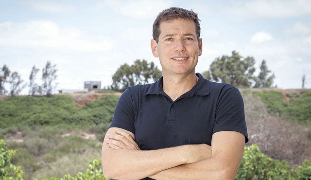 Mickey Kertesz outdoors in a navy polo shirt