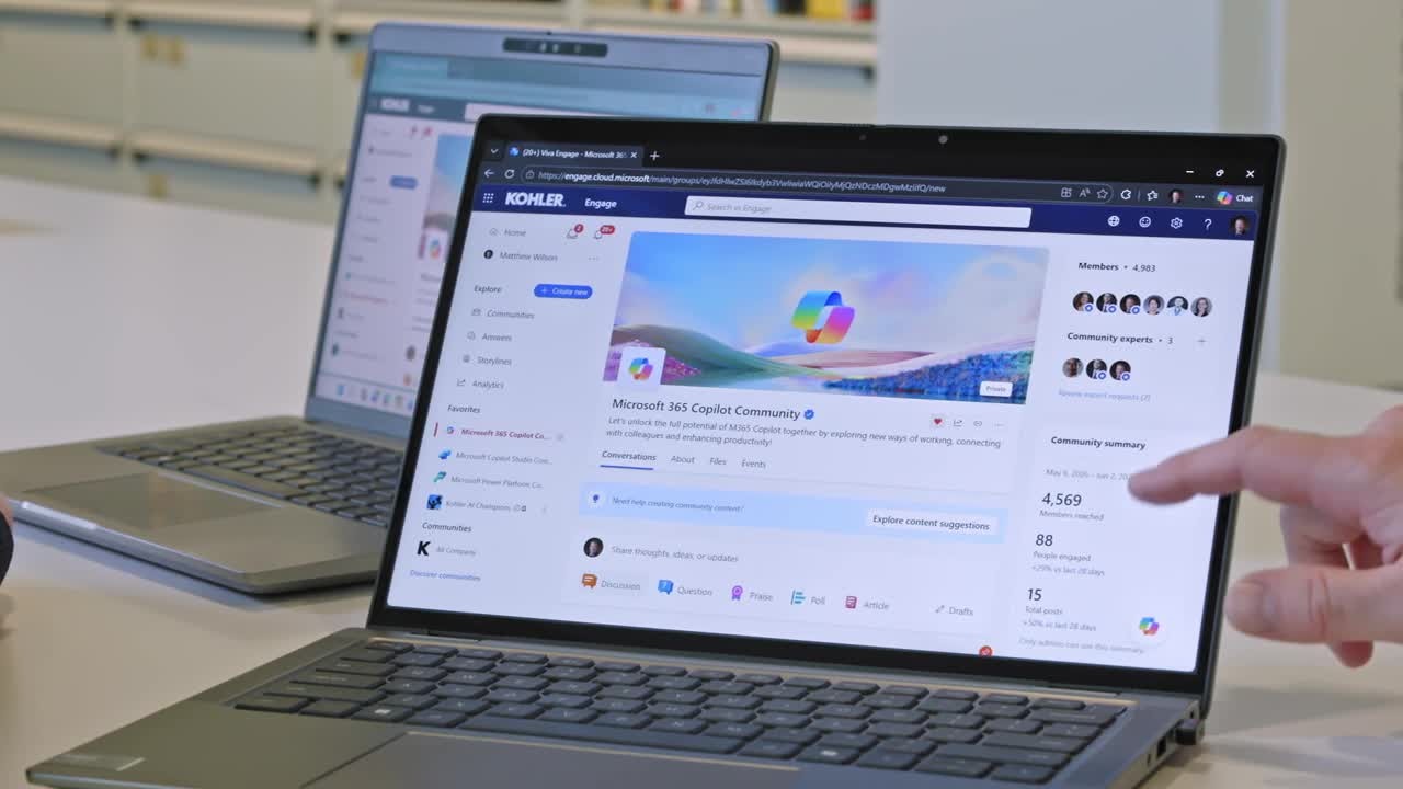 A laptop showing Kohler’s employee Copilot community in a Microsoft customer-story video