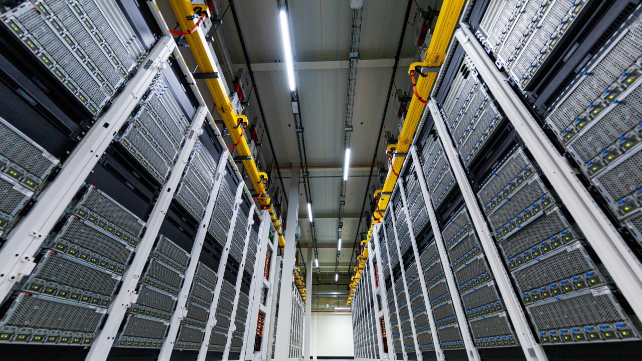 A low-angle view between server racks in a Microsoft datacenter