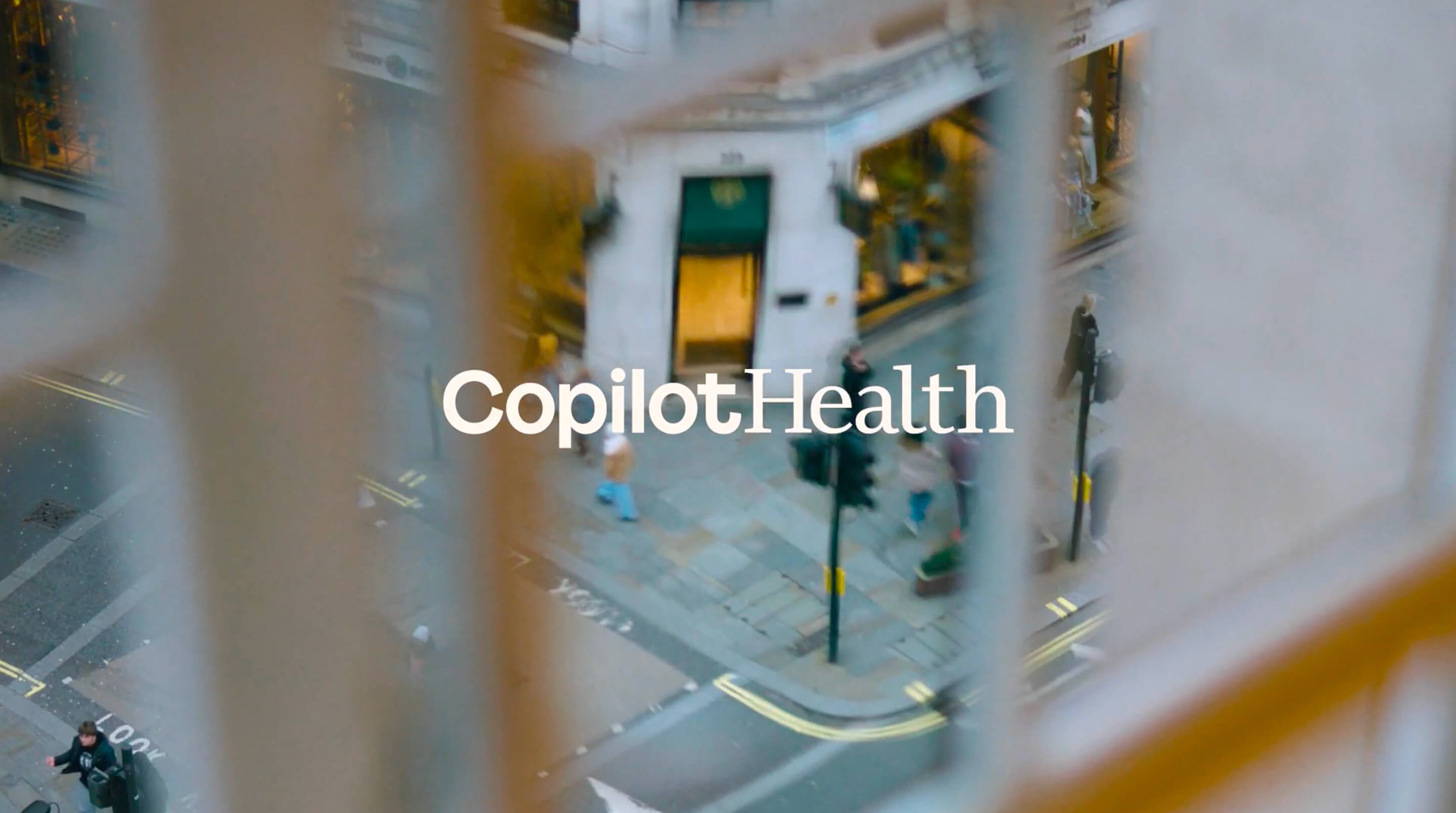 Copilot Health title over a blurred city street seen from above