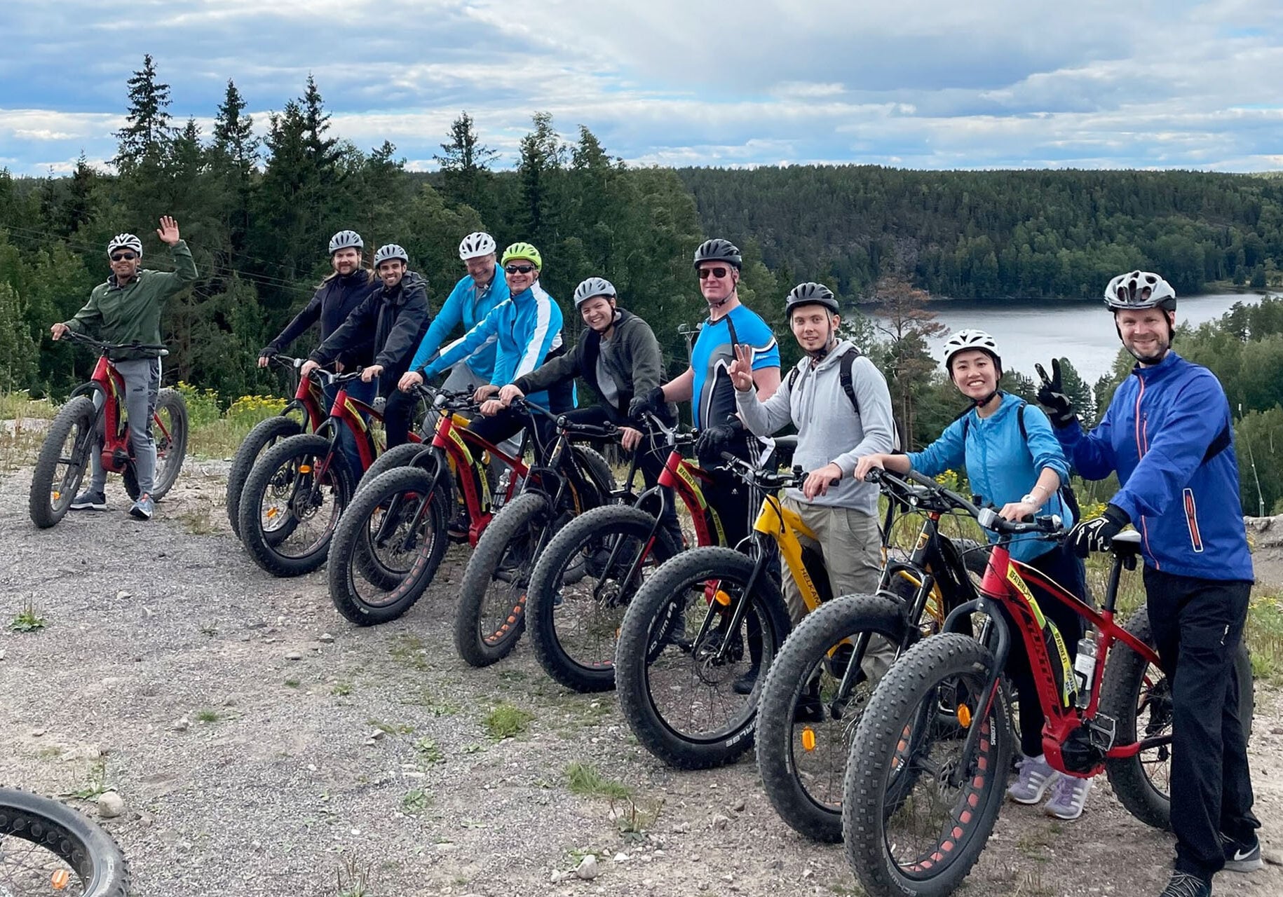 The Documill team with bicycles beside a lake and forest