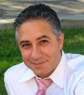 Mikayel Abramyan outdoors in a white shirt and pink tie