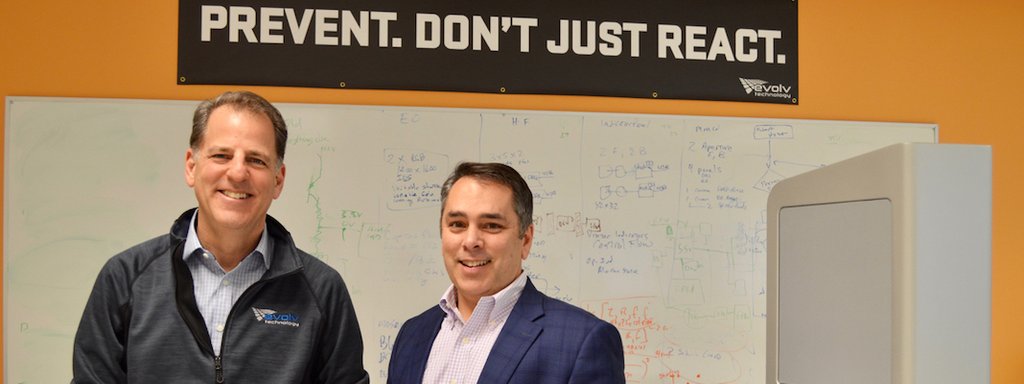 Mike Ellenbogen, left, and Anil Chitkara standing in Evolv’s office in front of a technical whiteboard.