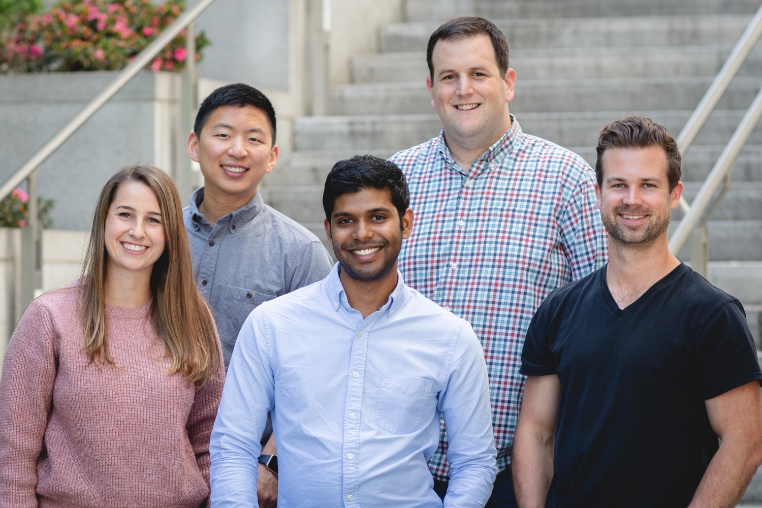 Mike Kadin, standing in a checked shirt, with RedCircle’s early team on outdoor steps