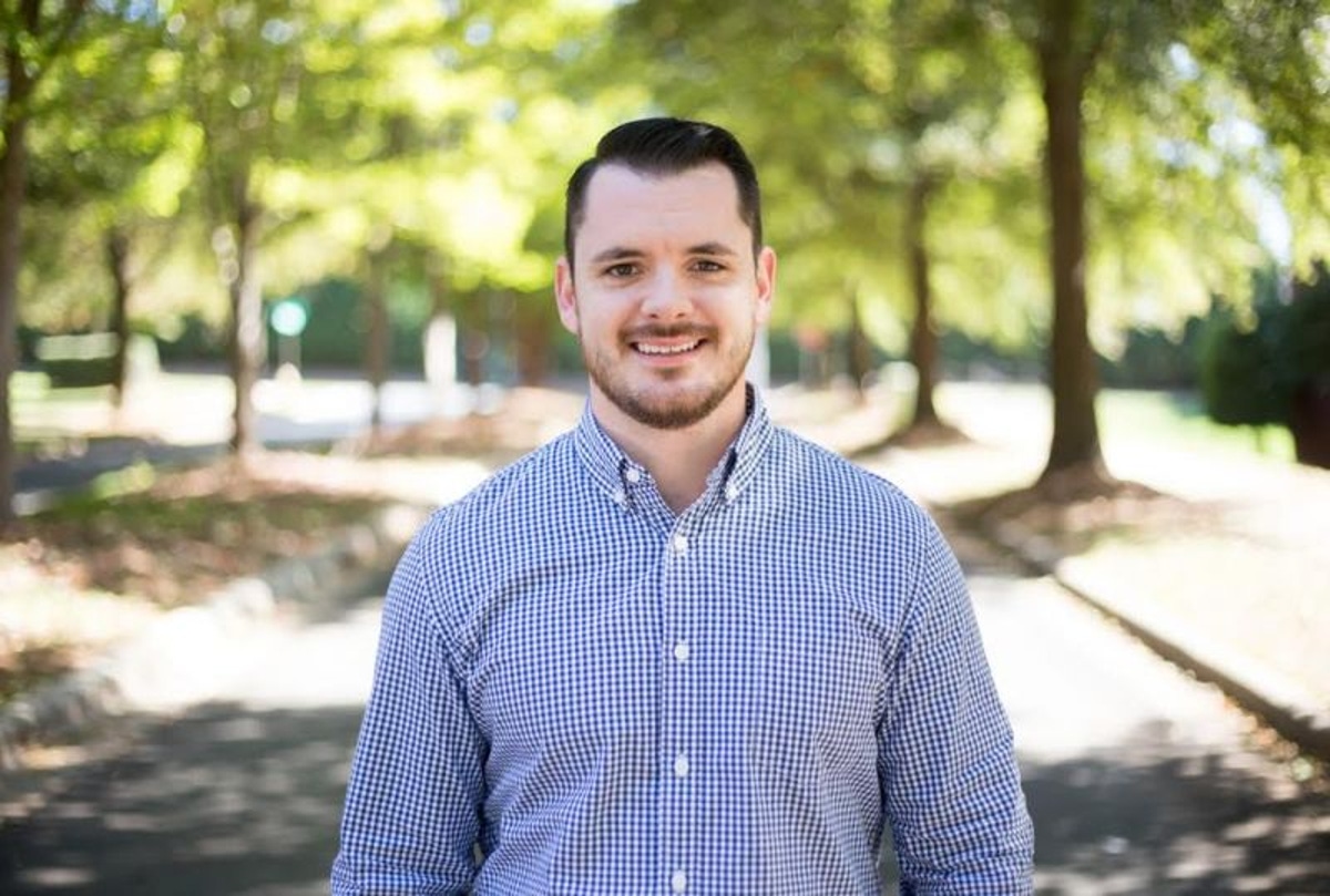 Mike Murphy standing outdoors in a checkered shirt