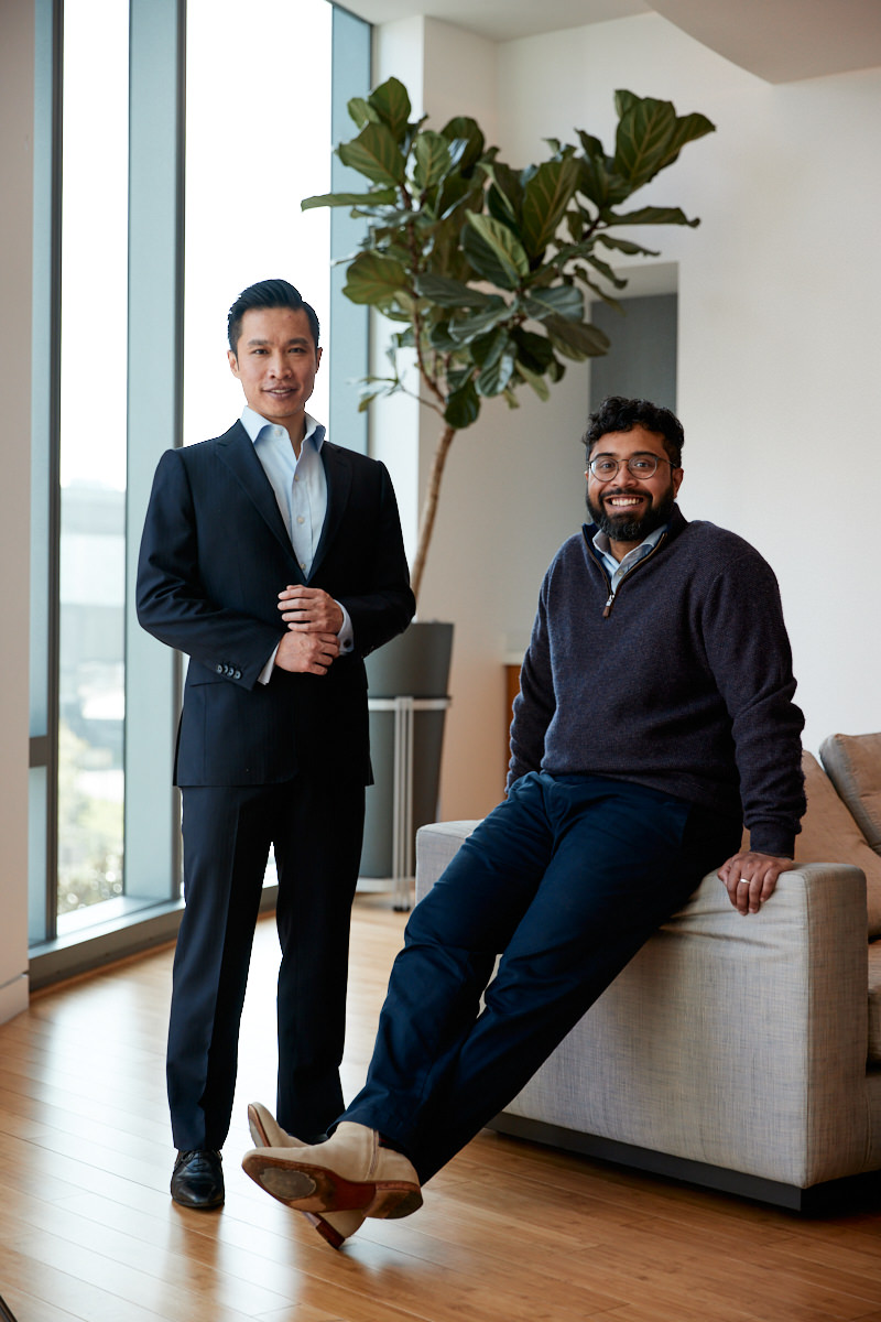 Mike Ng standing beside seated co-founder Nikhil Buduma