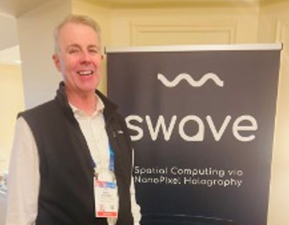 Mike Noonen standing beside a Swave display at CES