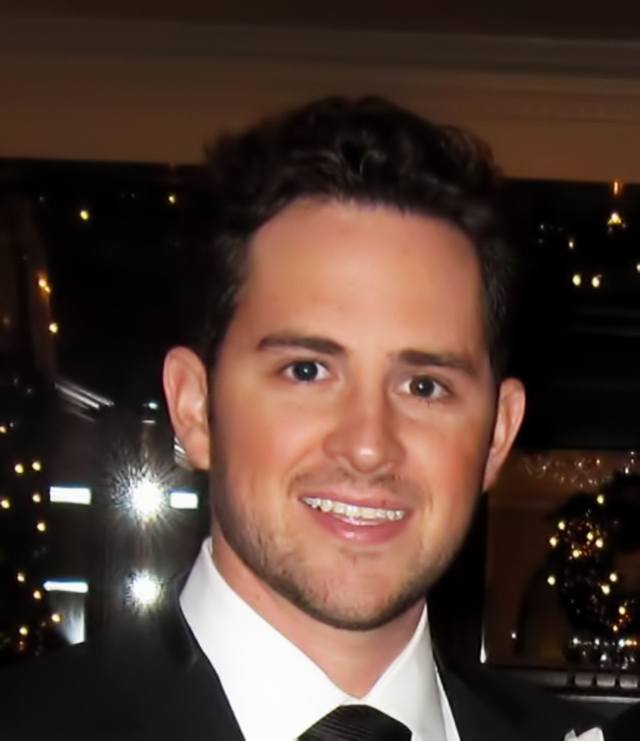 Mike Russell in a suit and tie, pictured in a photograph accompanying his Paintzen-era interview
