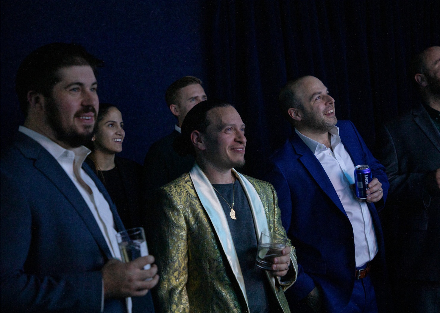 Mike Seiman, wearing a patterned jacket, among attendees at an event