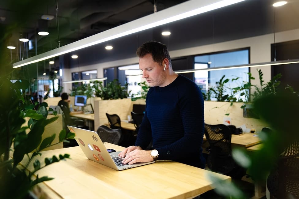 Mike Slaats working on a laptop at a shared office table