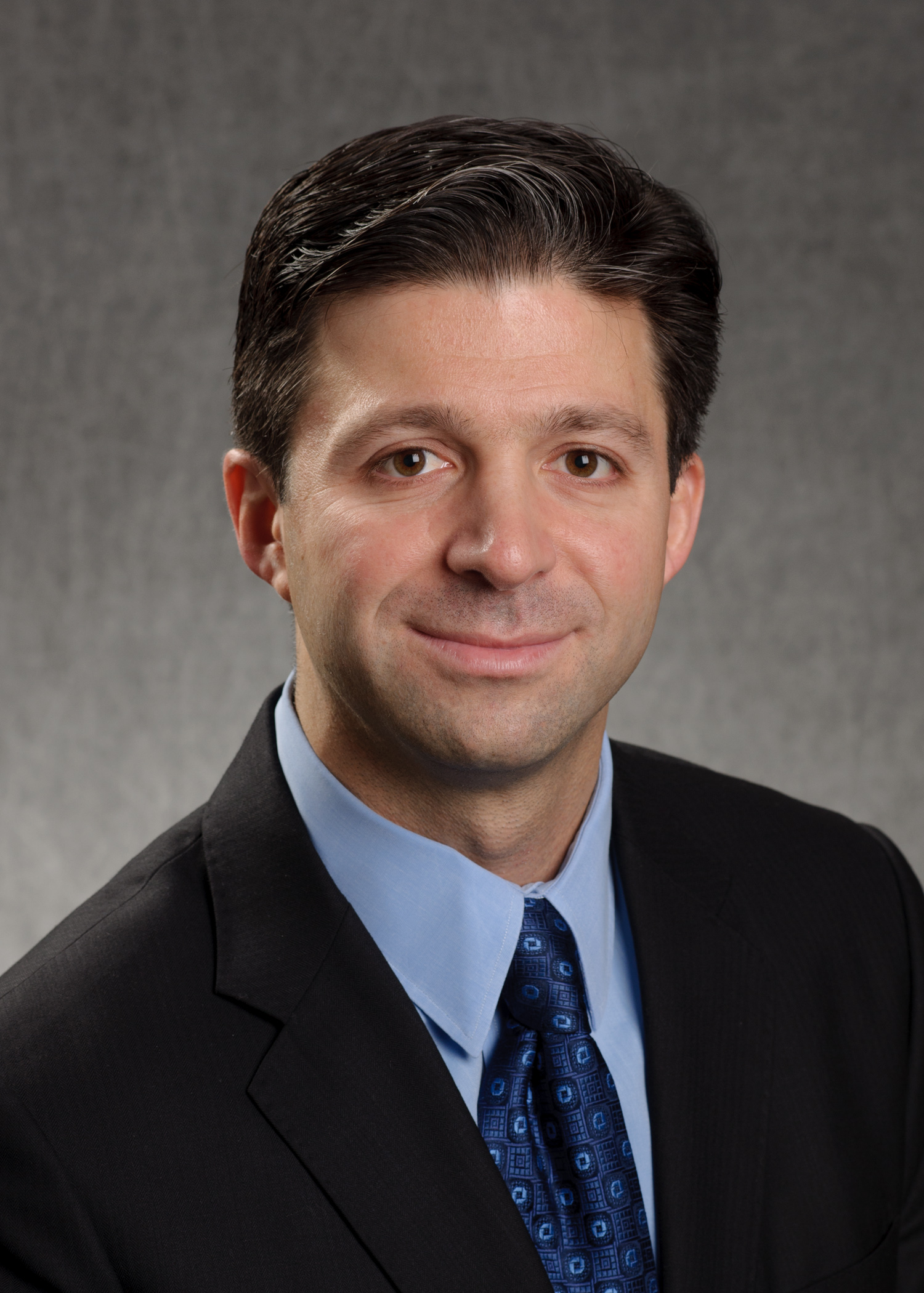 Archival Chase press portrait of Mike Weinbach in a suit and blue tie