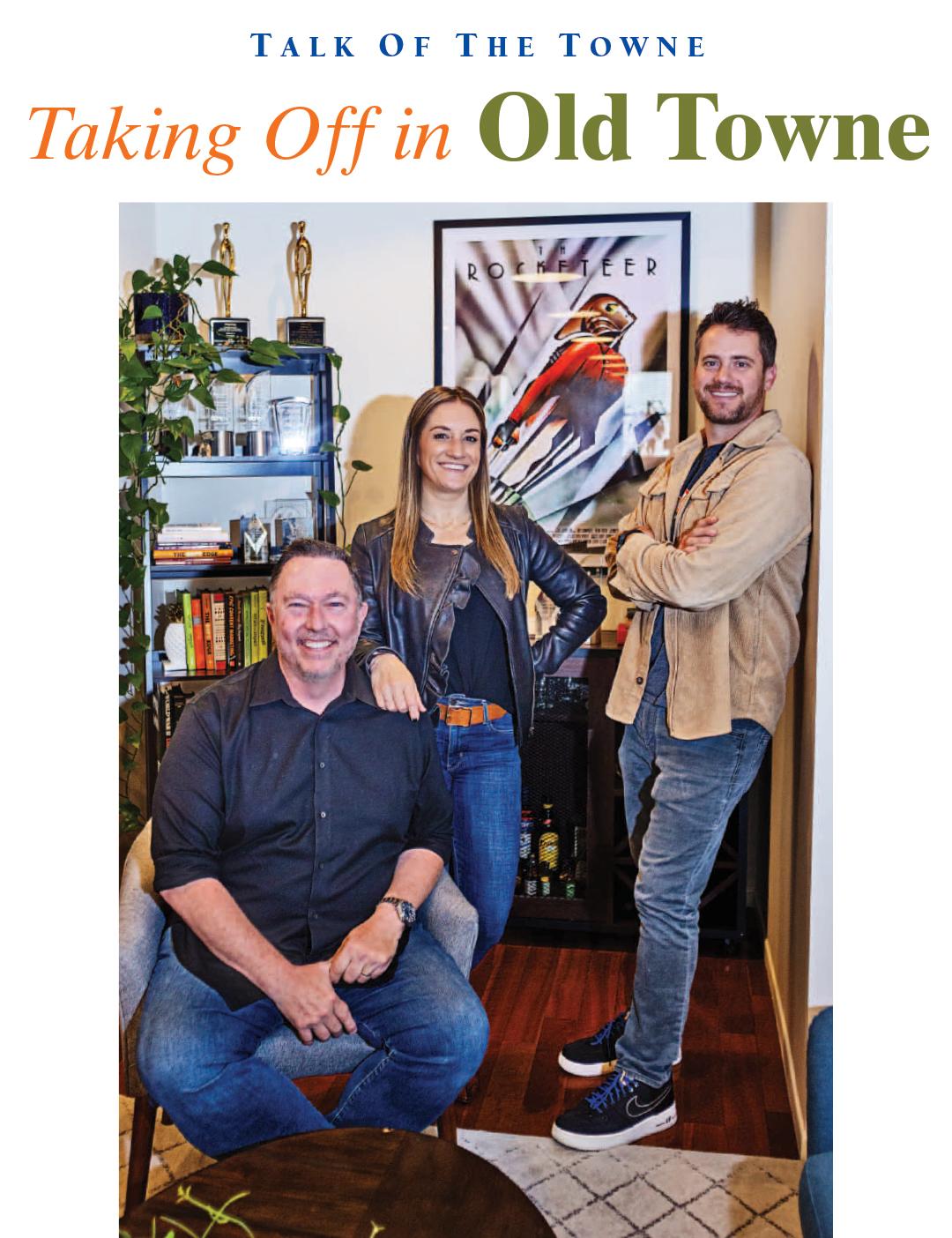 Mike Wheeler seated at left with Erin Gibbons and Dan Nasitka in the Rocket Launch office, as pictured in Orange Plaza Review