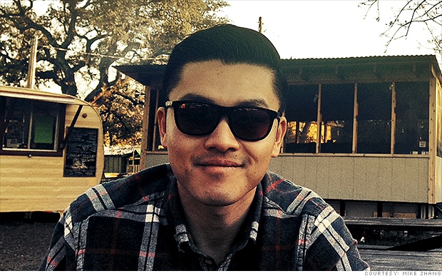 Mike Zhang wearing sunglasses and a plaid shirt in an outdoor photograph published in 2014