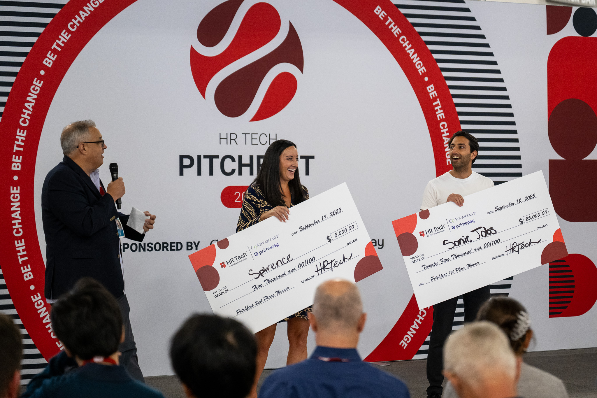 Mikhil Raja smiling on stage with the first-place check at the 2025 HR Tech Pitchfest