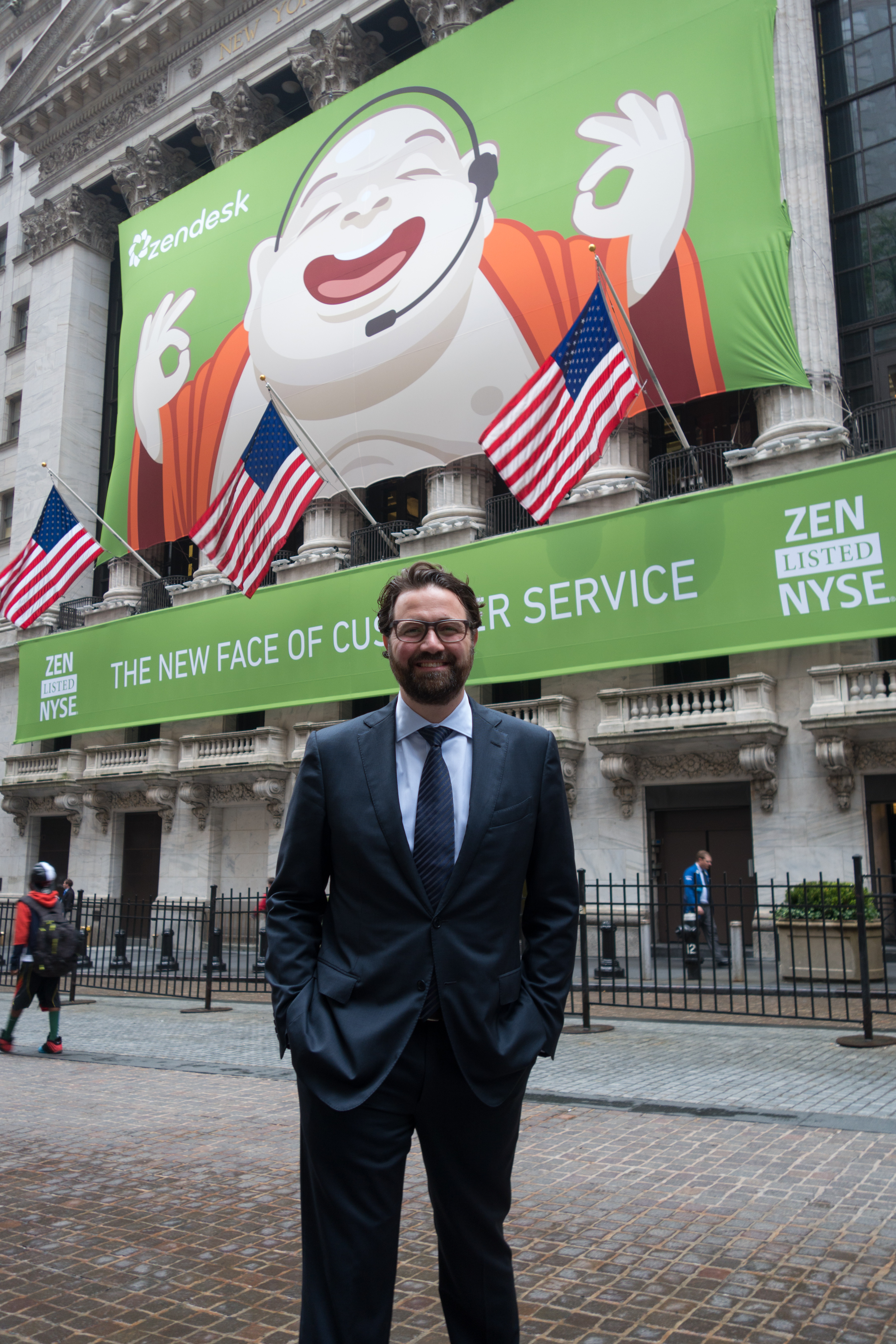Mikkel Svane outside the New York Stock Exchange beneath Zendesk’s green banner on its 2014 IPO day