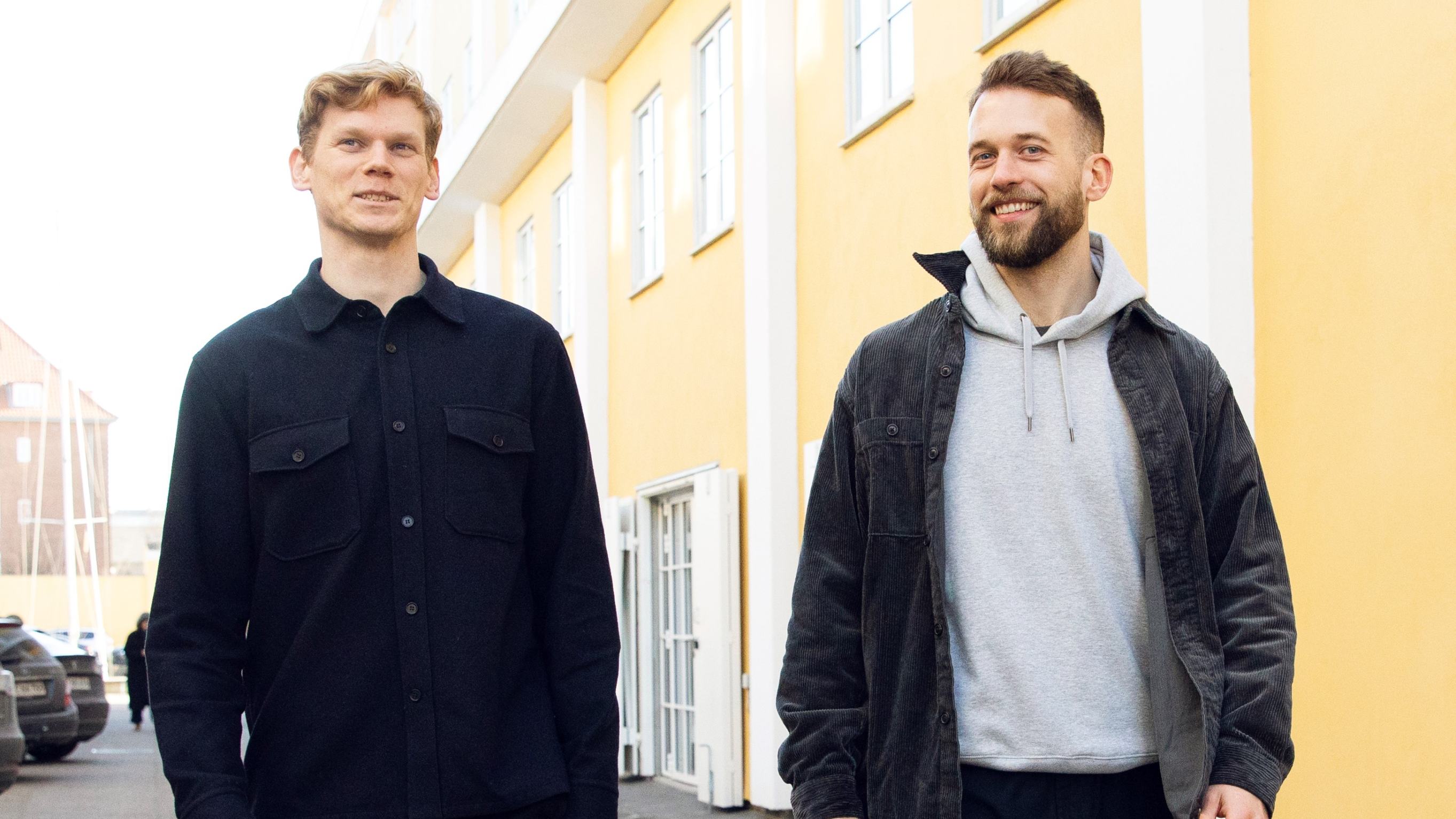 Teton co-founders Esben Klint Thorius and Mikkel Wad Thorsen walking beside a yellow building