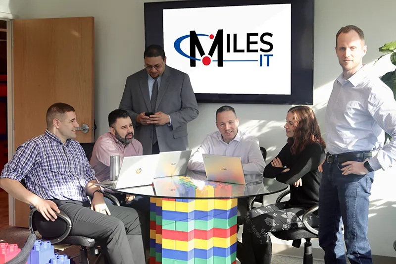 Miles IT colleagues gathered around a table for an IT leadership strategy meeting