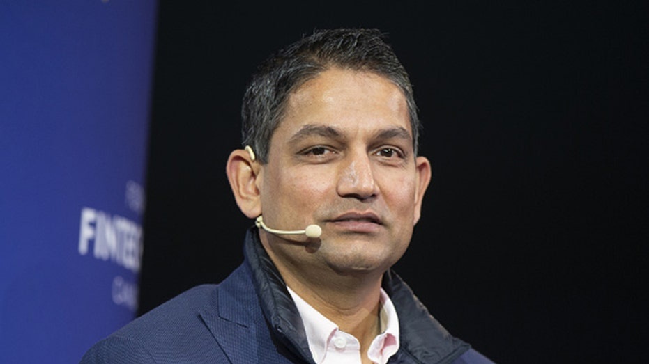 Milind Mehere wearing a headset microphone while speaking at the Canada Fintech Forum in Montreal