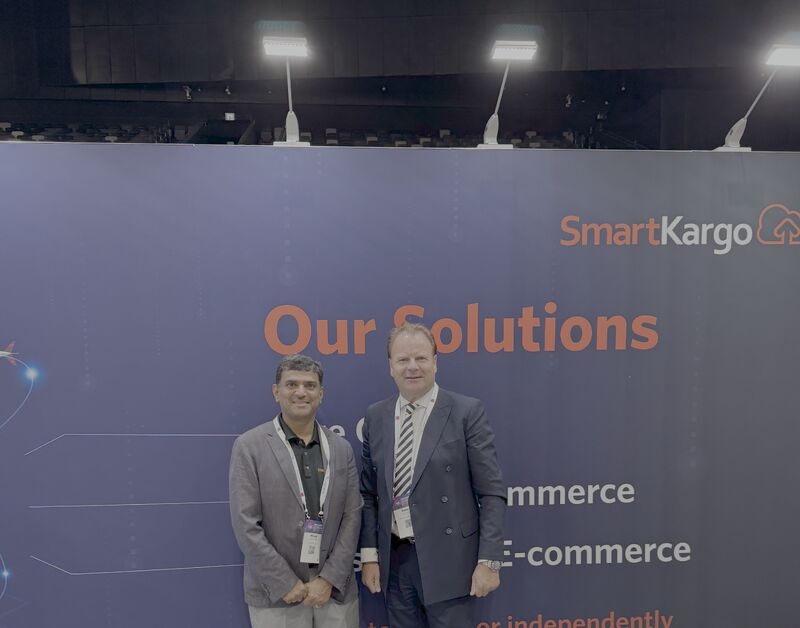 Milind Tavshikar, left, standing with Delta Cargo president Peter Penseel at a SmartKargo exhibition booth