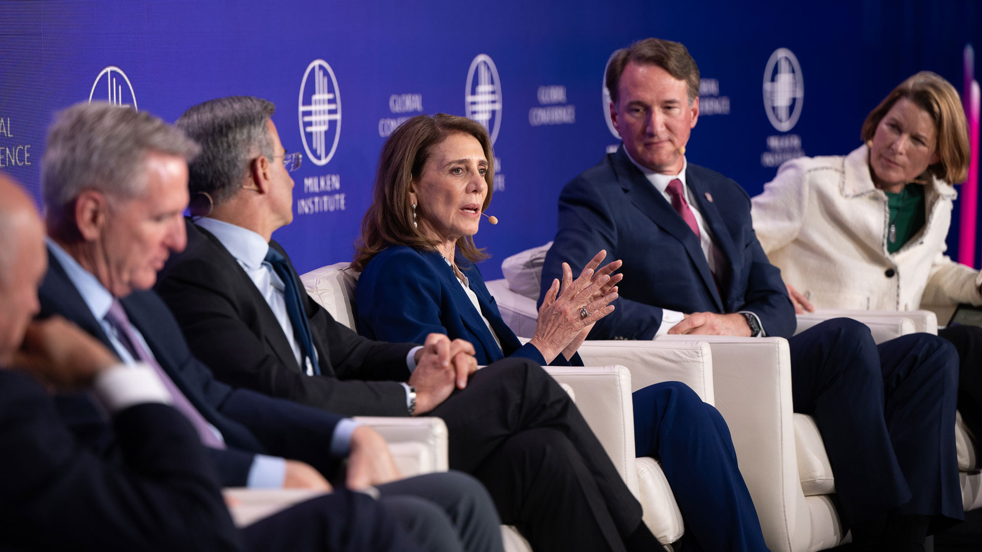 Speakers seated onstage during a Milken Institute Global Conference panel