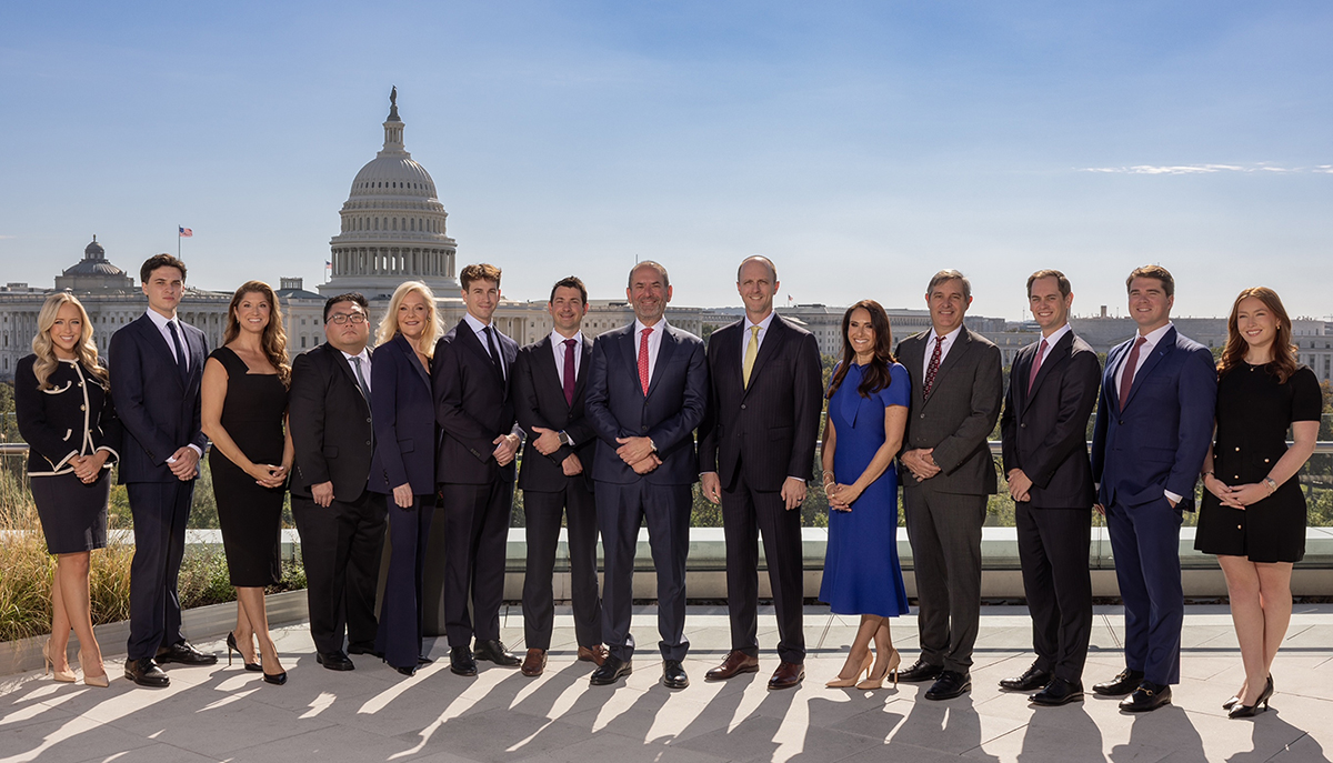 The Miller Strategies team standing on a terrace with the U.S. Capitol behind them