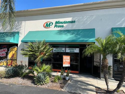 Minuteman Press Orange storefront with green awnings and palm trees
