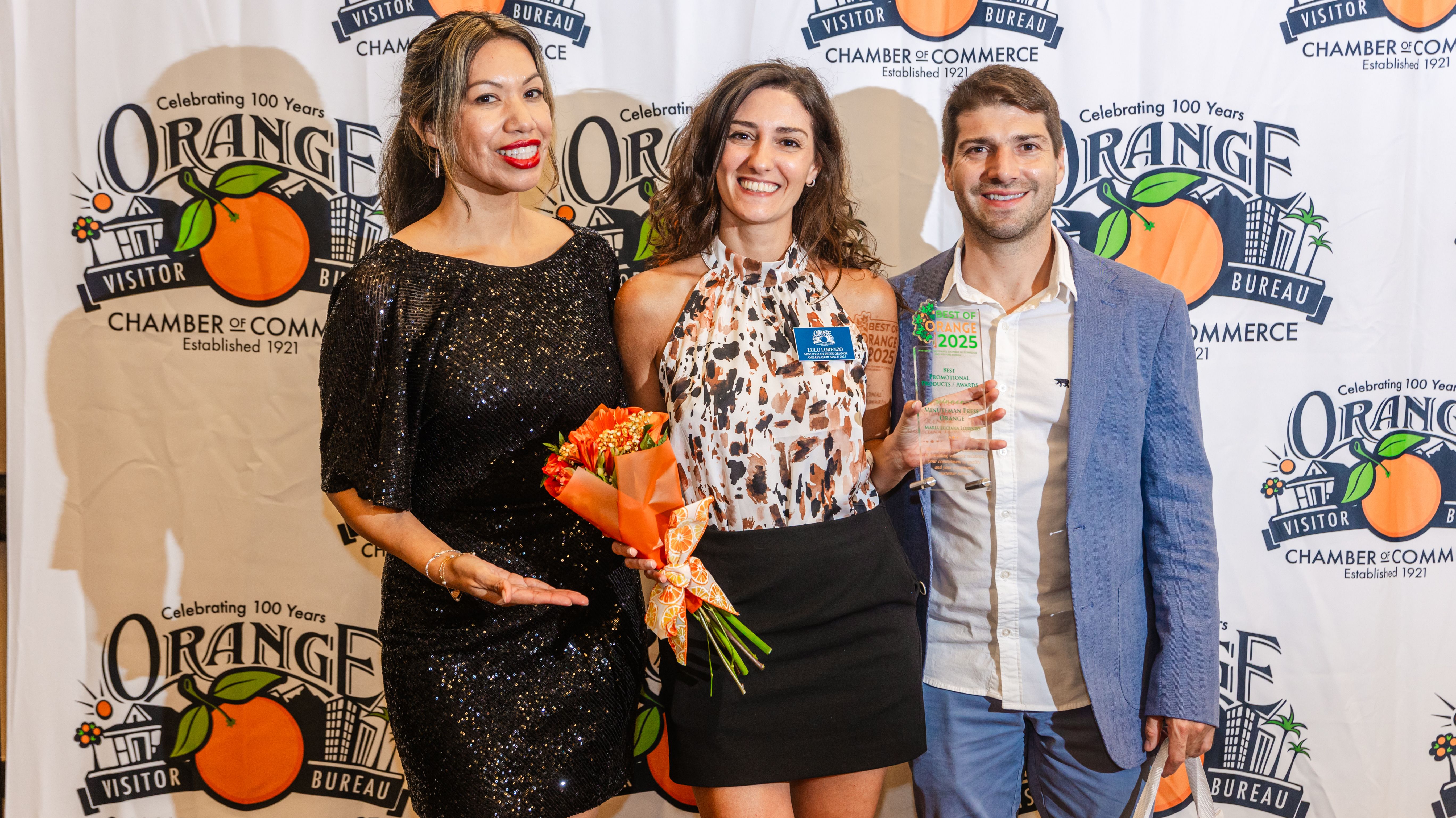 Luciana Lorenzo, center, holding an award at the Best of Orange event