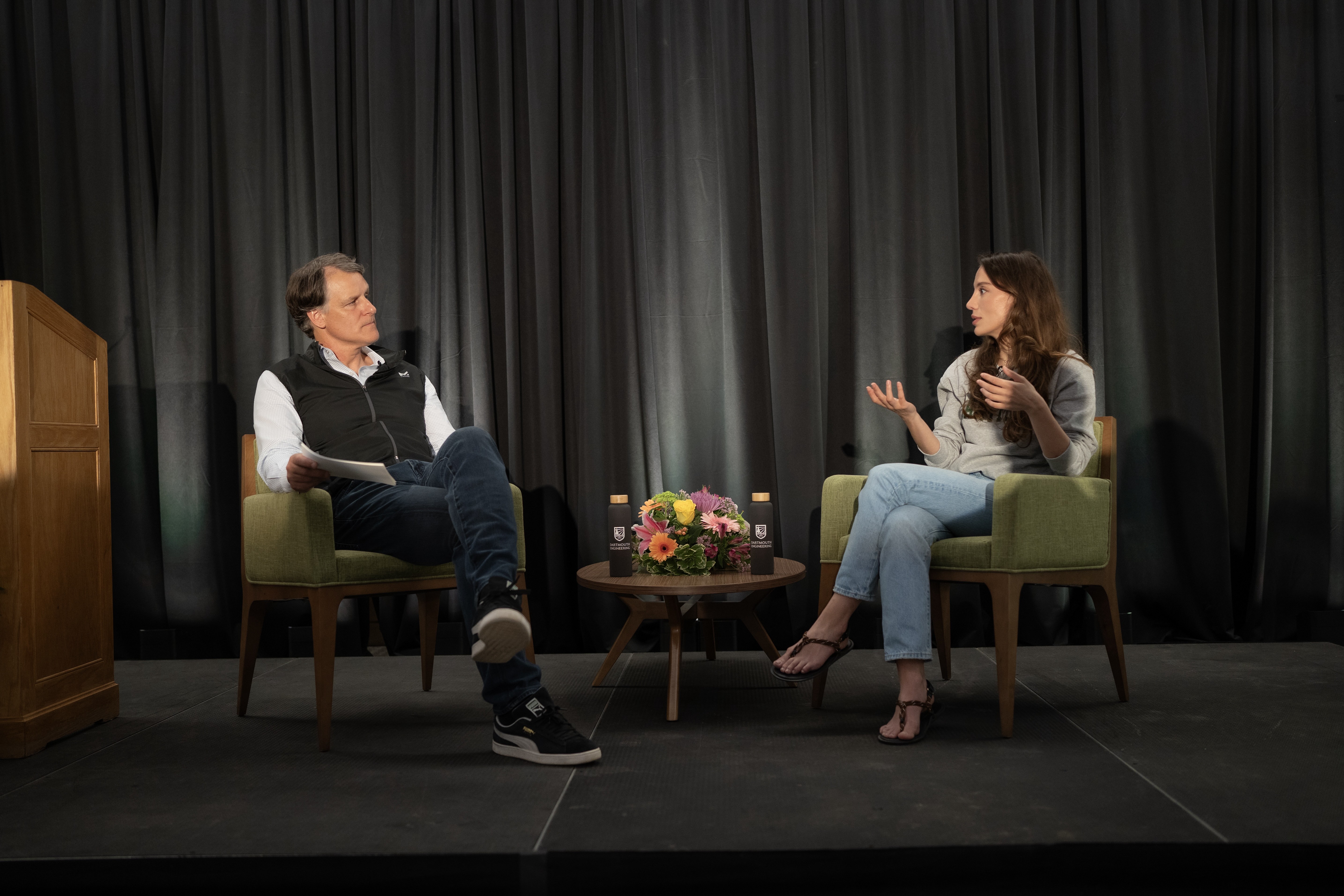 Mira Murati speaking with a moderator onstage at Dartmouth in 2024