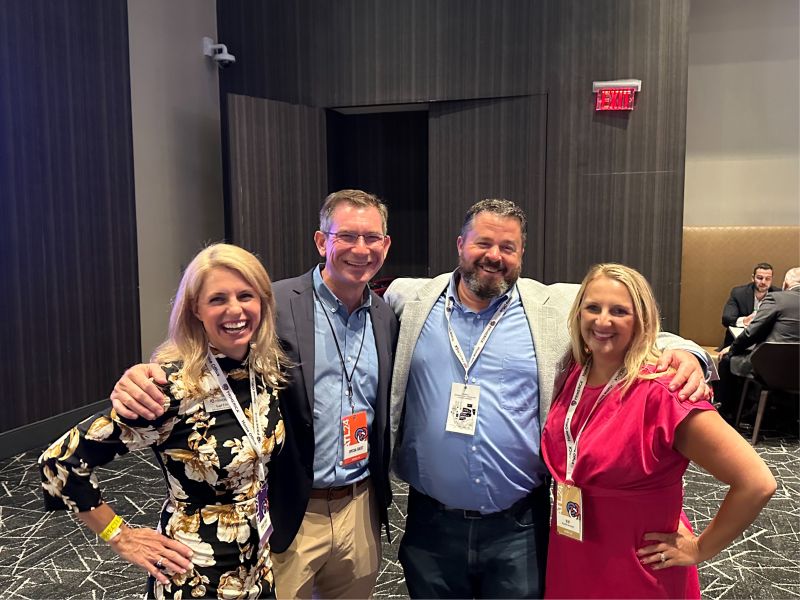 Misty Sutton, at right, smiling with three other convention attendees