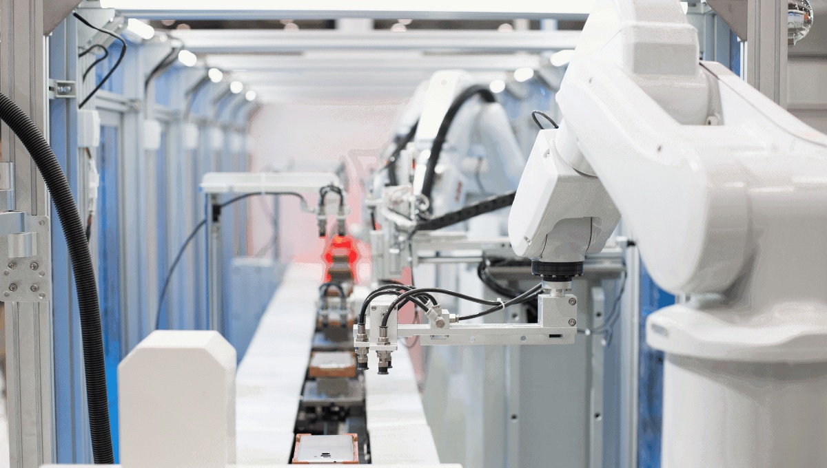 Industrial robotic arms beside an automated production line