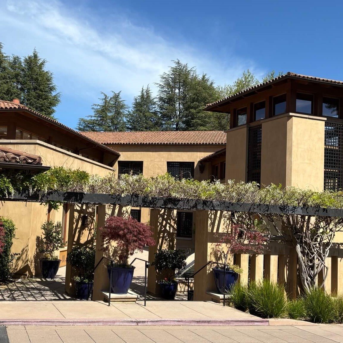 Sunlit courtyard and tiled-roof buildings at MGI’s Menlo Park office