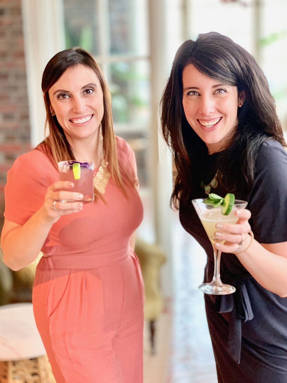 Mix+Shine founders Rachael Seda and April Sciacchitano holding cocktails