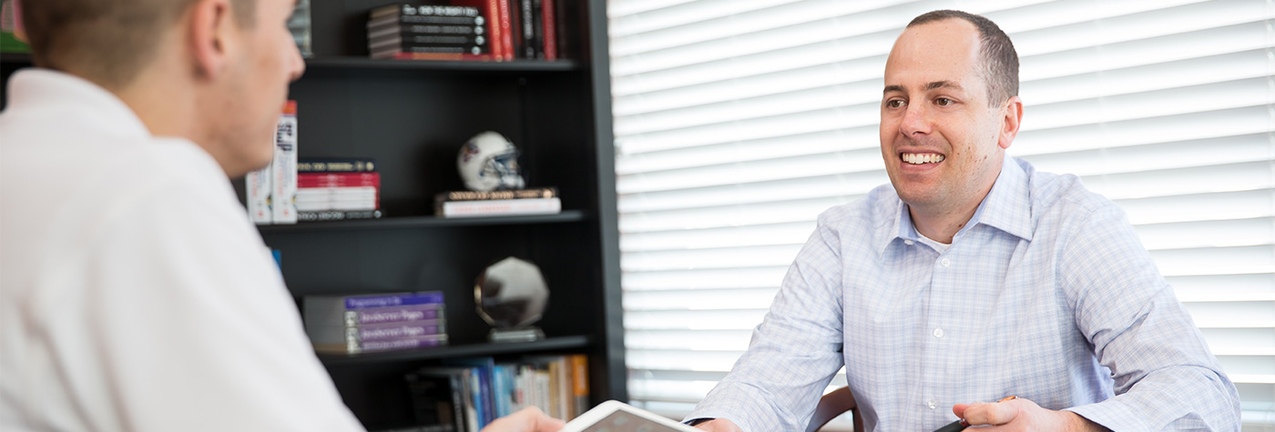 MJ Wivell, on the right, in an office conversation with his cofounder Jeremy Nimtz.