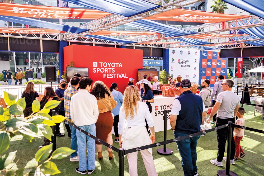 Visitors queue inside the bright red and blue Toyota Sports Festival activation