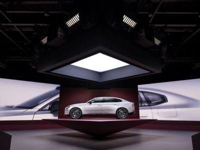A silver Volvo displayed beneath a square light installation