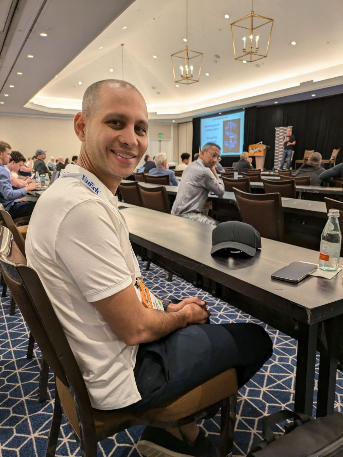 Mo Al Adham seated in a conference room shortly before speaking onstage
